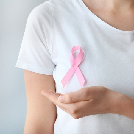 Person Wearing Pink Ribbon for Breast Cancer Awareness